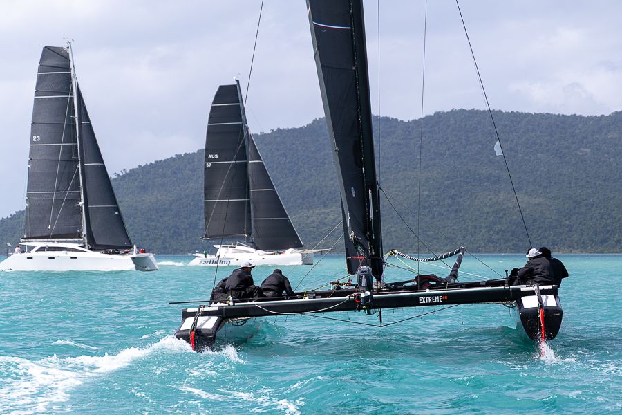 Three racing vessels in the water Airlie Beach