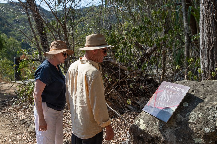 couple reading sign along a forest hike australia
