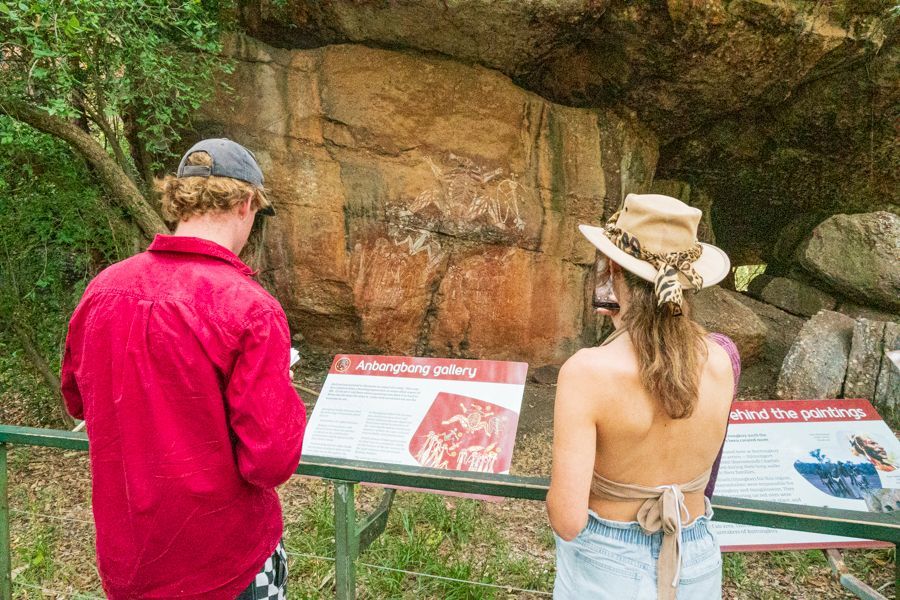 people admiring indigenous rock art in kakadu national park