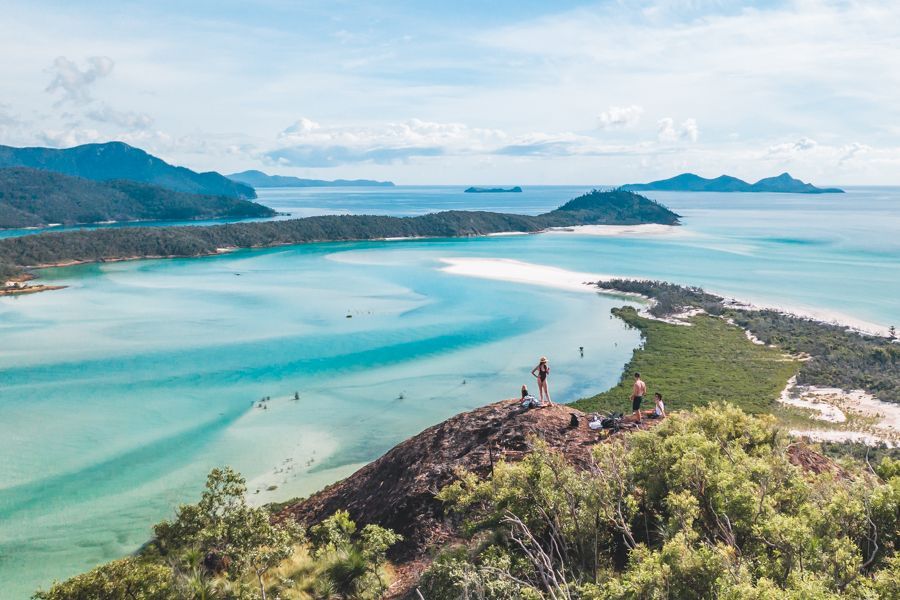people hiking on whitsunday island near whitehaven beach