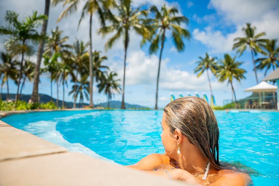 girl sitting in pool at hamilton island whitsundays