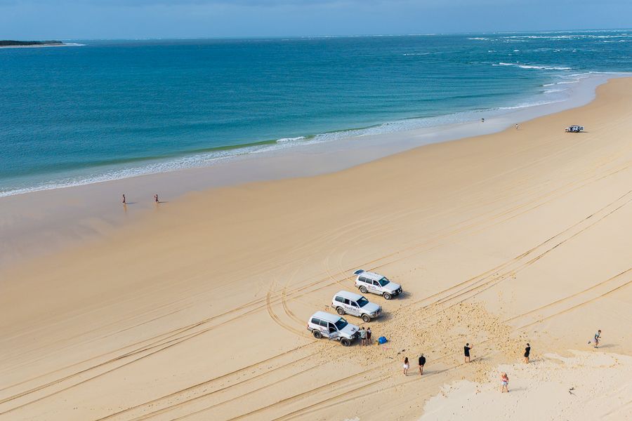 4wd cars parked on the sand along K'gari beach
