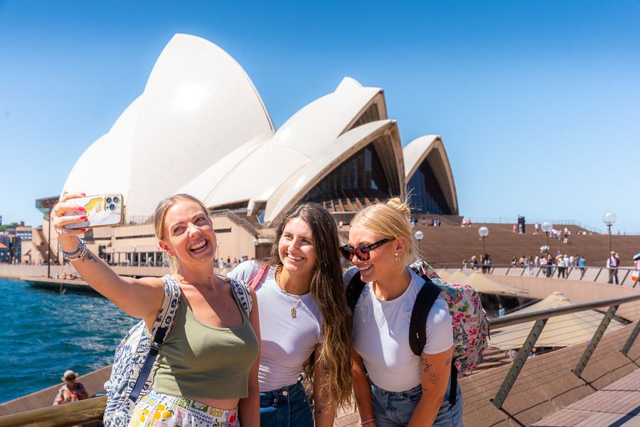 girls smiling in front of sydney opera house australia