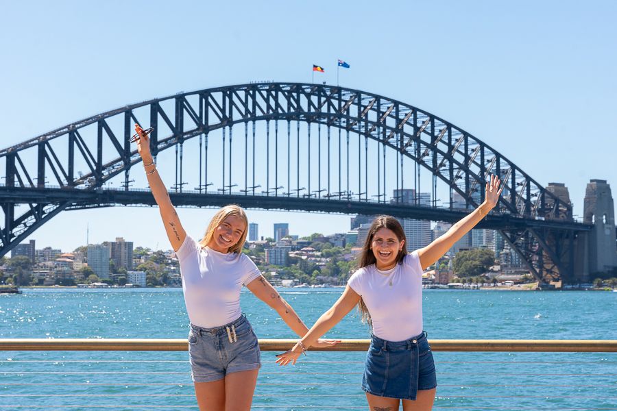 two girls posing in front of sydney harbour bridge