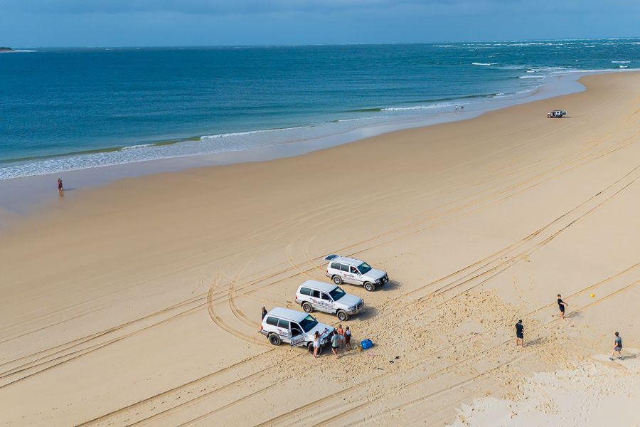 aerial view of kgari beach with 4wd vehicles