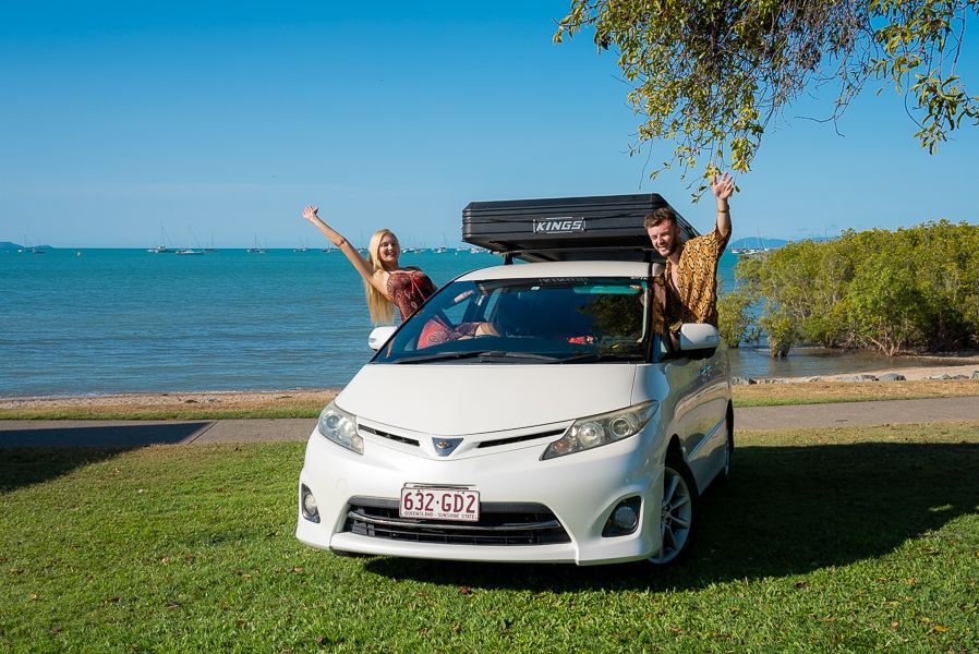 couple in a campervan on the coast of airlie beach