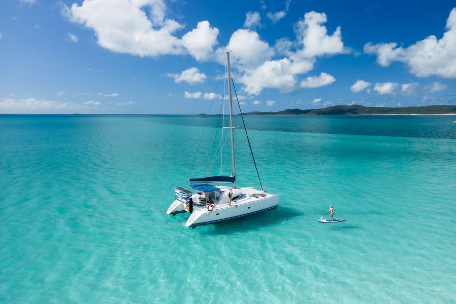 catamaran and paddleboarder in the whitsundays