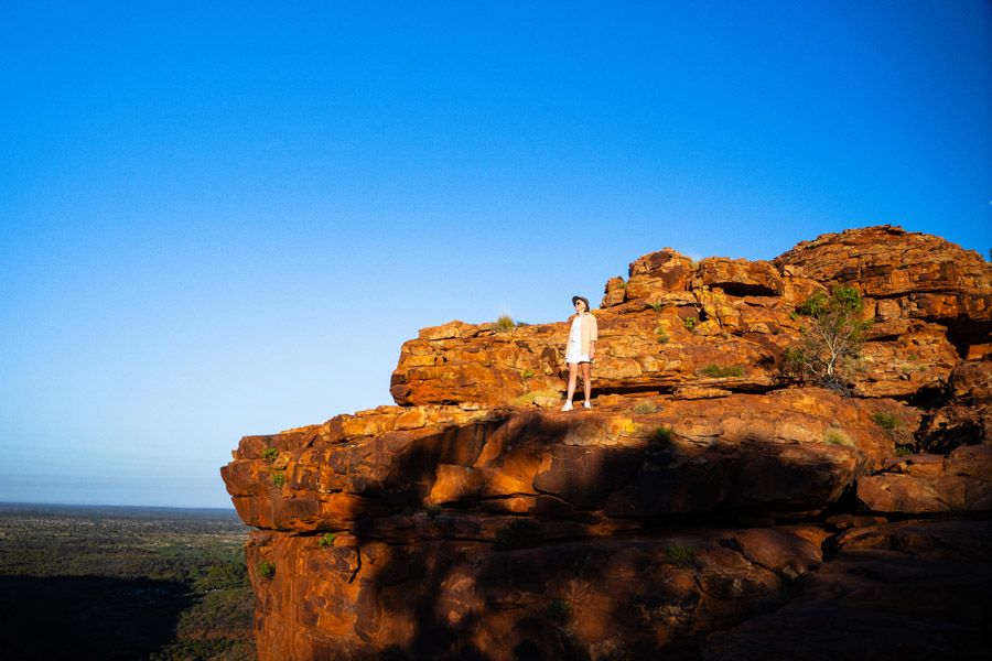 hiker exploring rocks around the red centre australia
