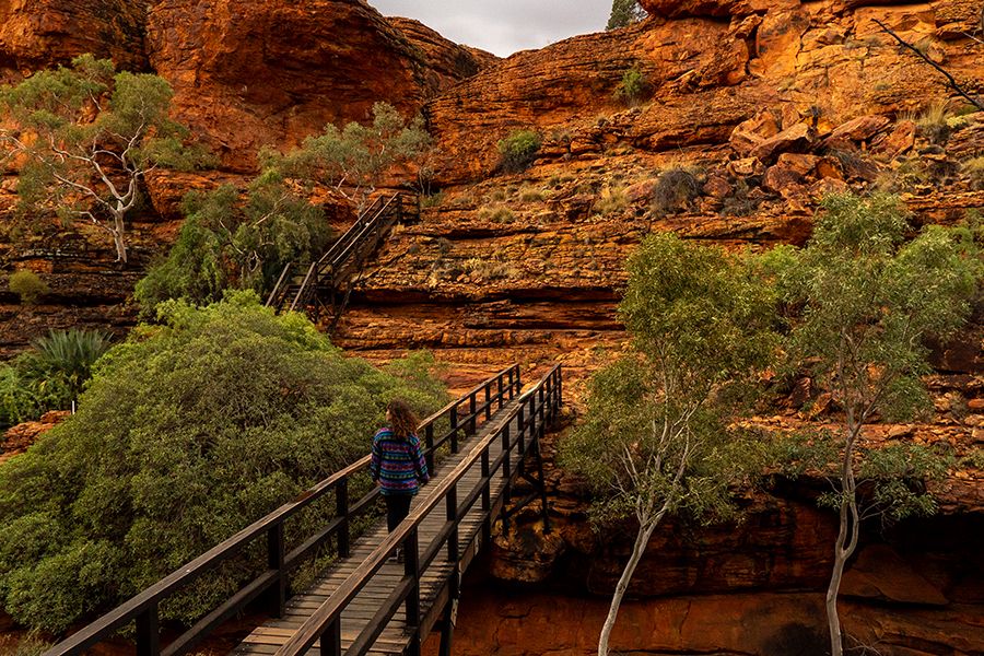 girl hiking along bridge in kings canyon australia