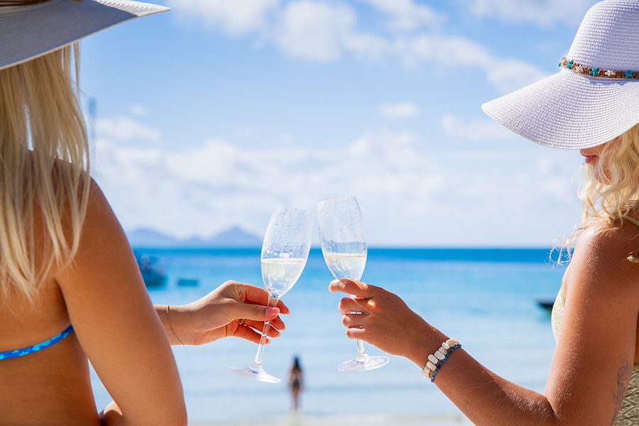 Whitehaven Beach Whitsundays girls clinking glasses on whitehaven beach whitsundays
