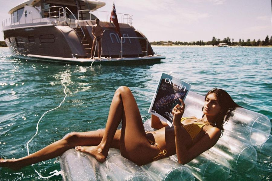 Nisi Superyacht girl lounging on a float near nisi superyacht