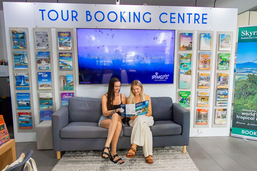 Travel Shop Cairns two travellers looking at tour brochures in a travel shop