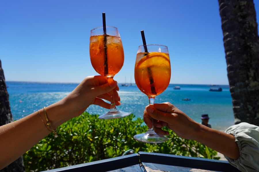 Cocktails Fitzroy Island Cairns two people holding up cocktails on fitzroy island near cairns