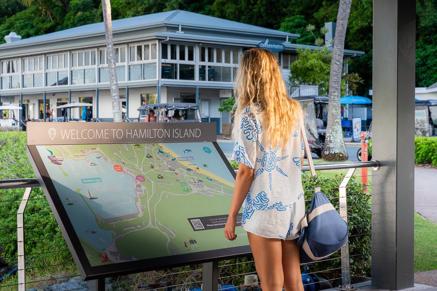 Hamilton Island girl reading the welcome sign at hamilton island