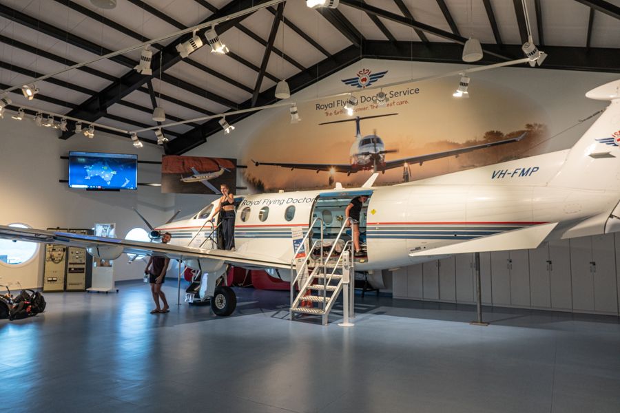 people on a model plane at royal flying doctor service museum