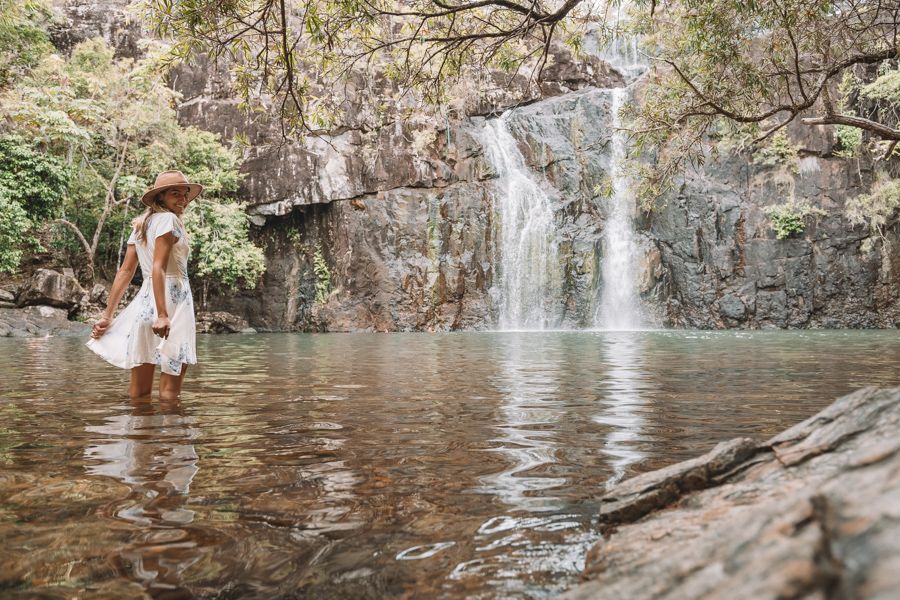 Women wearing a dress and hat at Cedar Creek Falls