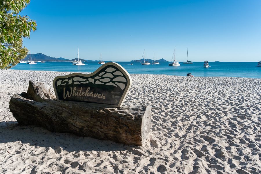 A sign on a beach that reads 'Whitehaven Beach'