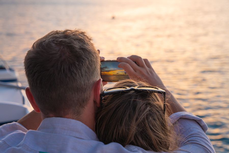 couple watching sunset on whitehaven catamaran