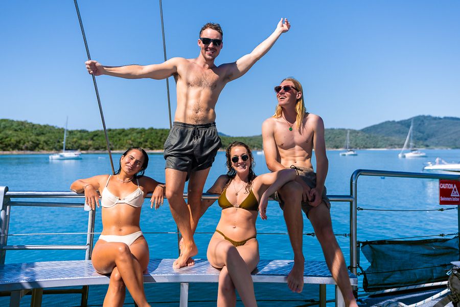 Group of backpackers chilling on a boat