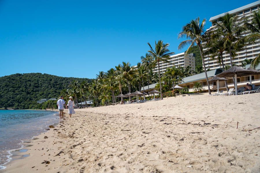 couple walking on catseye beach on Hamilton Island