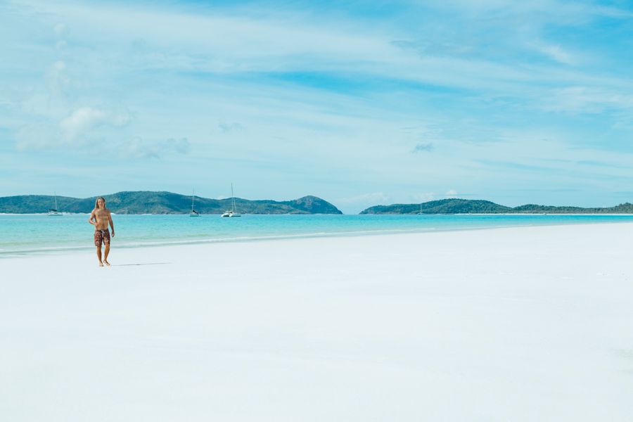 guy walking on whitehaven beach