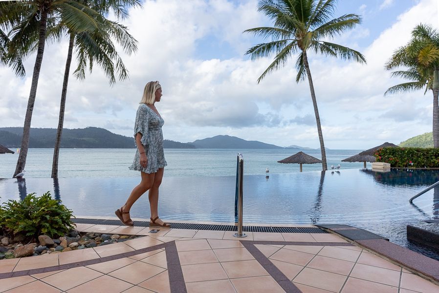 girl walking along hamilton island resort whitsundays