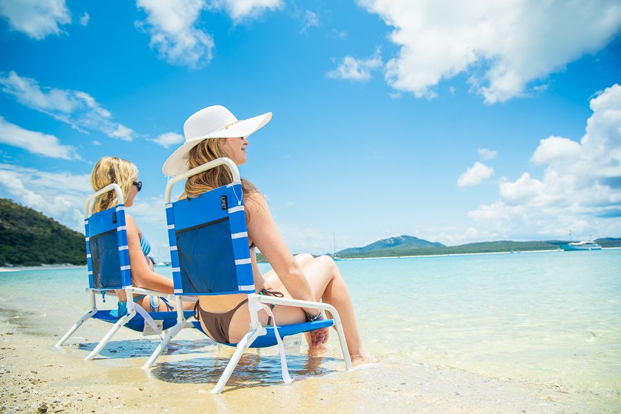 two girls sitting in beach chairs on whitehaven