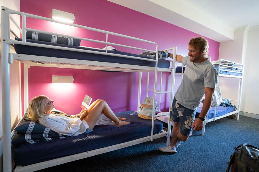 Man saying hey to a woman in a bunk hostel 