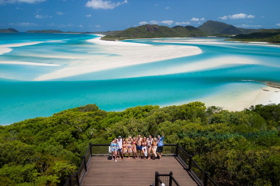 An island in the distance with blue water in front of it