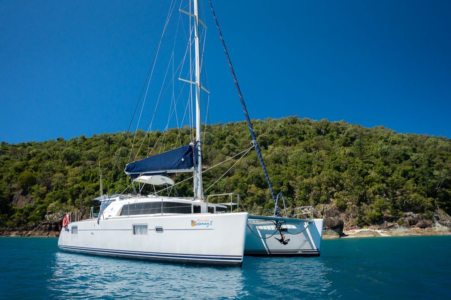A drone shot of a sailing catamaran