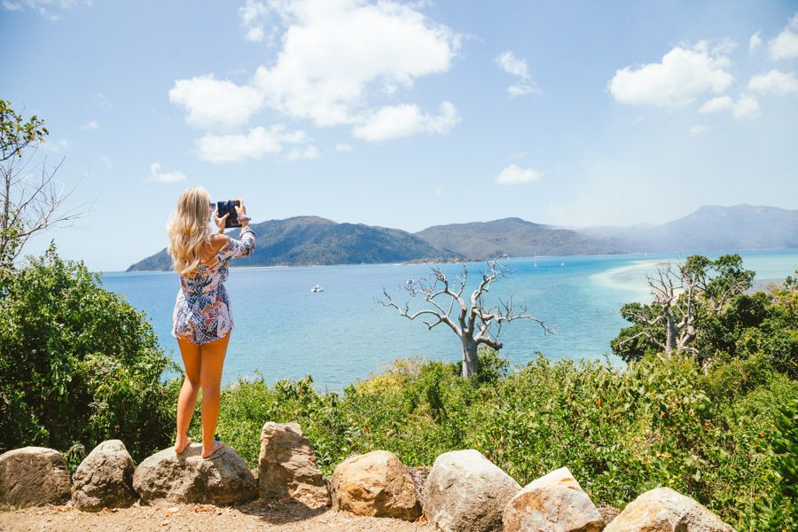 Girl taking a photograph at Langford Island Lookout, Whitsundays, Australia