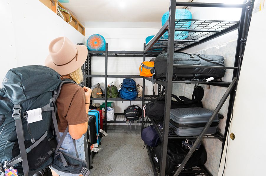 Backpacker storing their luggage at The Travel Shop Bag Storage Facility.