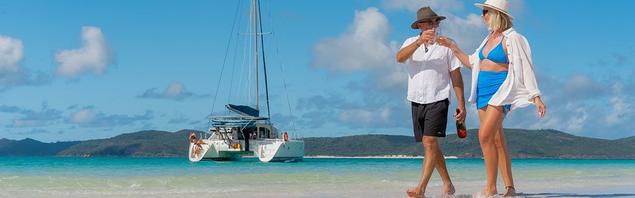 Whitehaven Beach Couple walking along Whitehaven Beach