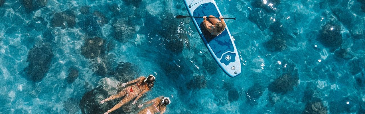 Snorkelling on the Reef Snorkellers and Paddle-boarder Aerial Image